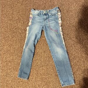 Gently used DKNY sparkly jeans with friendship strings